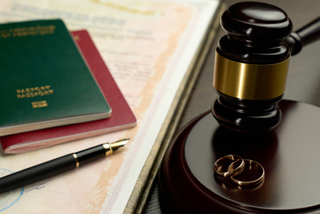 Image of gavel, wedding rings and passports