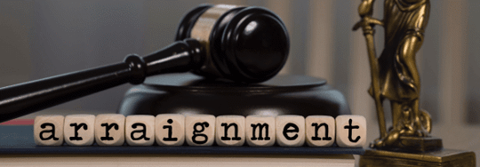 Judges gavel with letters spelling "Arraignment"