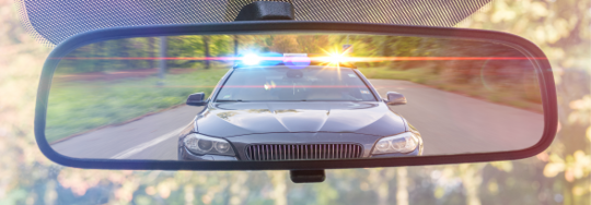 Police car in rearview mirror
