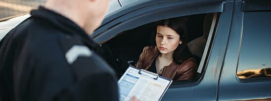 young woman receiving traffic ticket