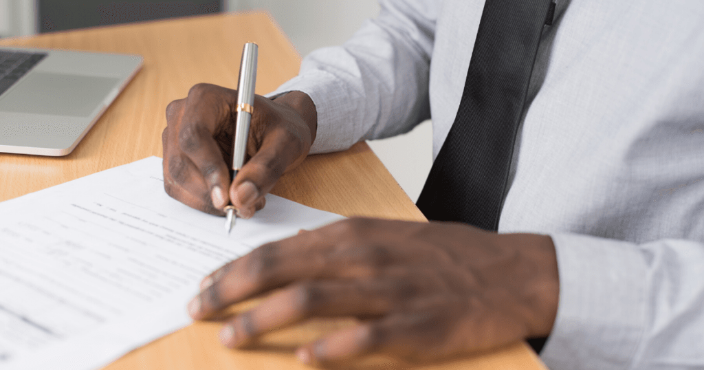 man filling out document