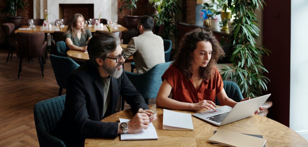 man and woman working on computer