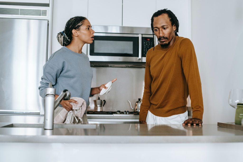 man and woman arguing in kitchen