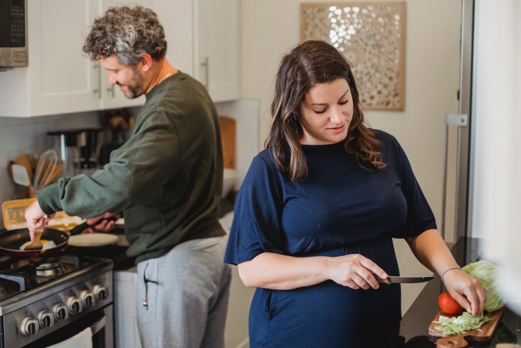 man and woman cooking together