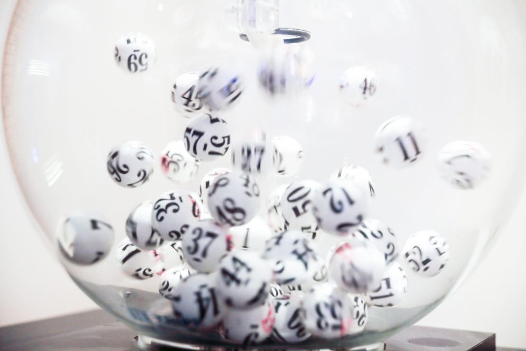 Photograph of numbered lottery balls in motion. Representing the concept of an immigration lottery.