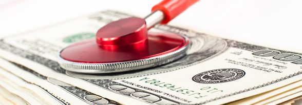 dollars cosulted with a red stethoscope close-up on white background