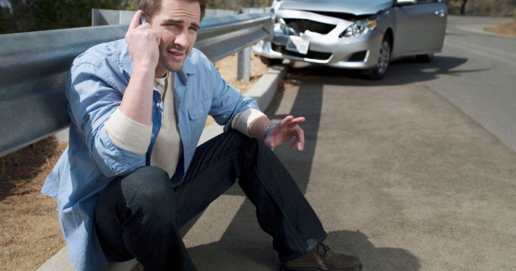 man on roadside calling after an accident