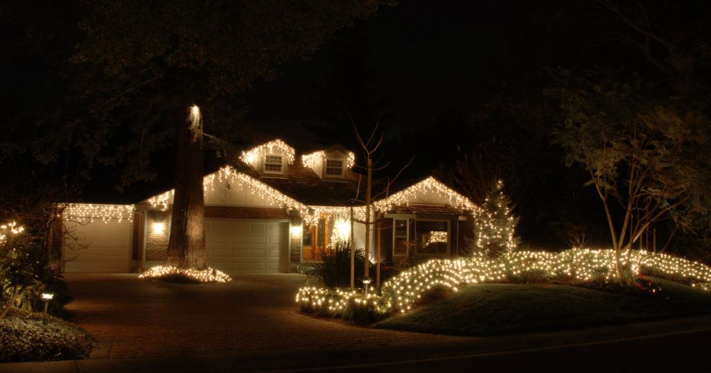home exterior lit up by holiday lights