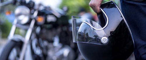 A man holding a motorcycle helmet