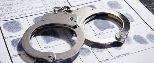 A pair of handcuffs on recorded finger prints in association with drug charges 